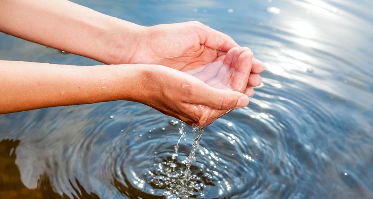 Testing water purity by cupping water in hands